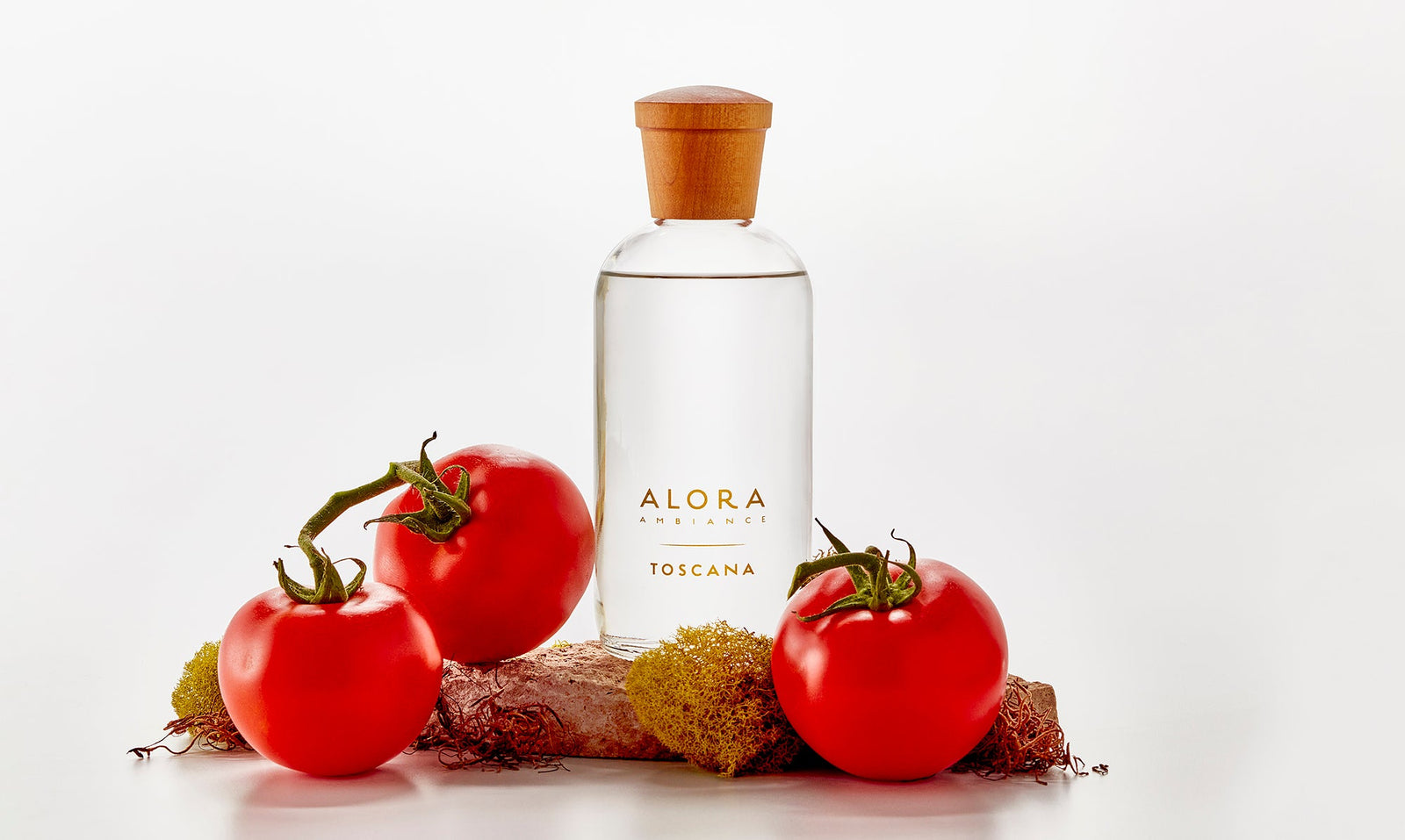 Toscana diffuser bottle and vine-ripened tomatoes and moss