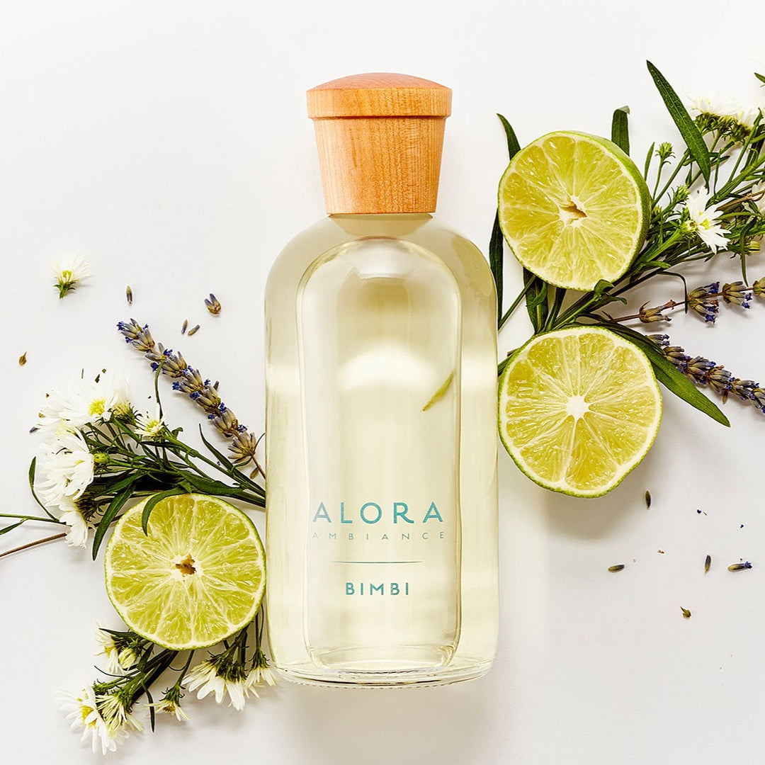 Bimbi diffuser bottle by bergamot halves, lavender sprigs, and chamomile flowers