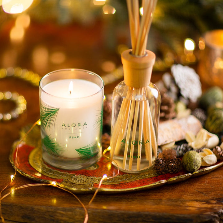 Pino candle and reed diffuser on decorative tray filled with potpourri