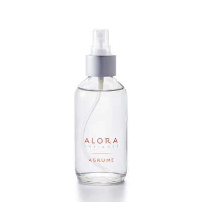 Small glass spray bottle with "Alora Ambiance" and "Agrume" written on the front.