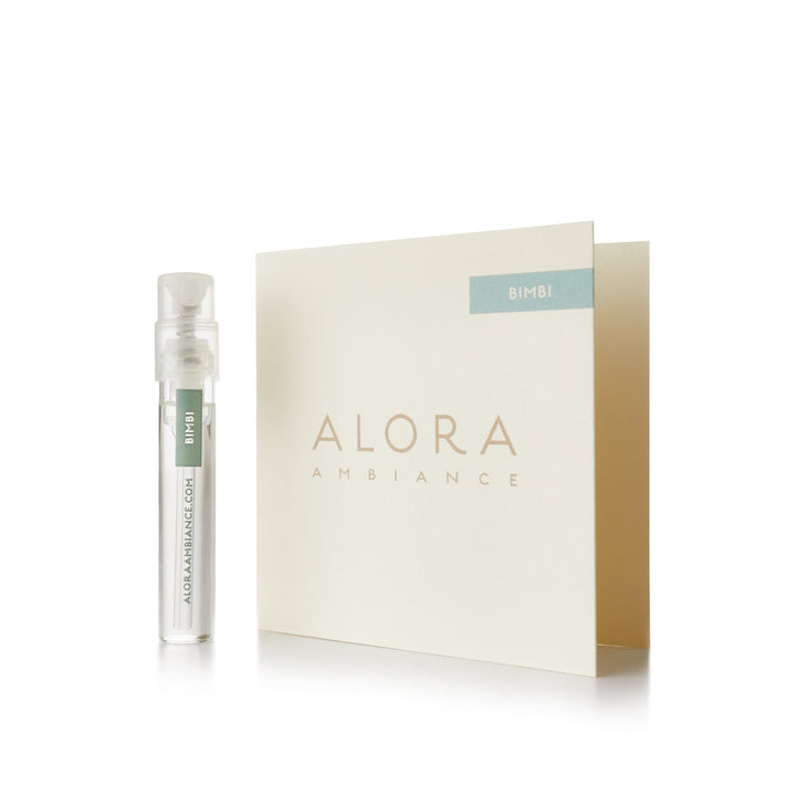Small clear plastic vial that says “Alora Ambiance” and “Bimbi” next to a tan card that also says “Alora Ambiance" and “Bimbi”
