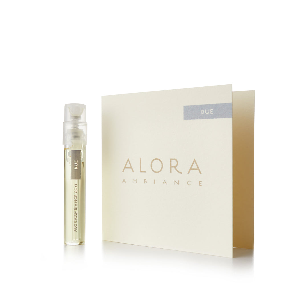 Small clear plastic vial that says “Alora Ambiance” and “Due” next to a tan card that also says “Alora Ambiance" and “Due”