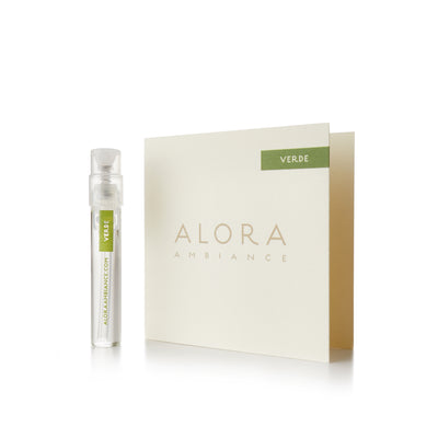 Small clear plastic vial that says “Alora Ambiance” and “Verde” next to a tan card that also says “Alora Ambiance" and “Verde”