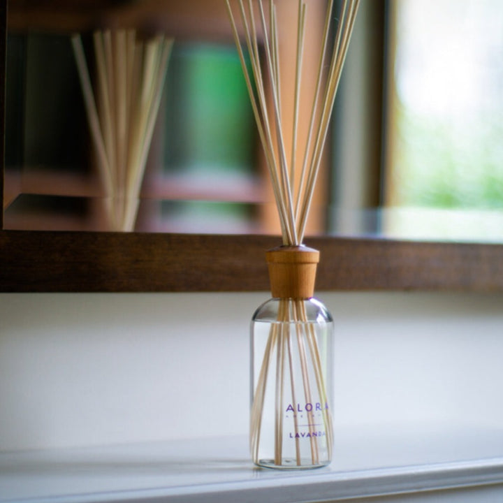 Lavanda reed diffuser on shelf in front of mirror
