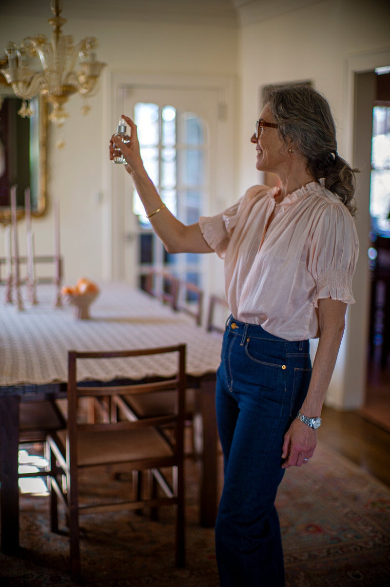 therese spritzing room spray in home