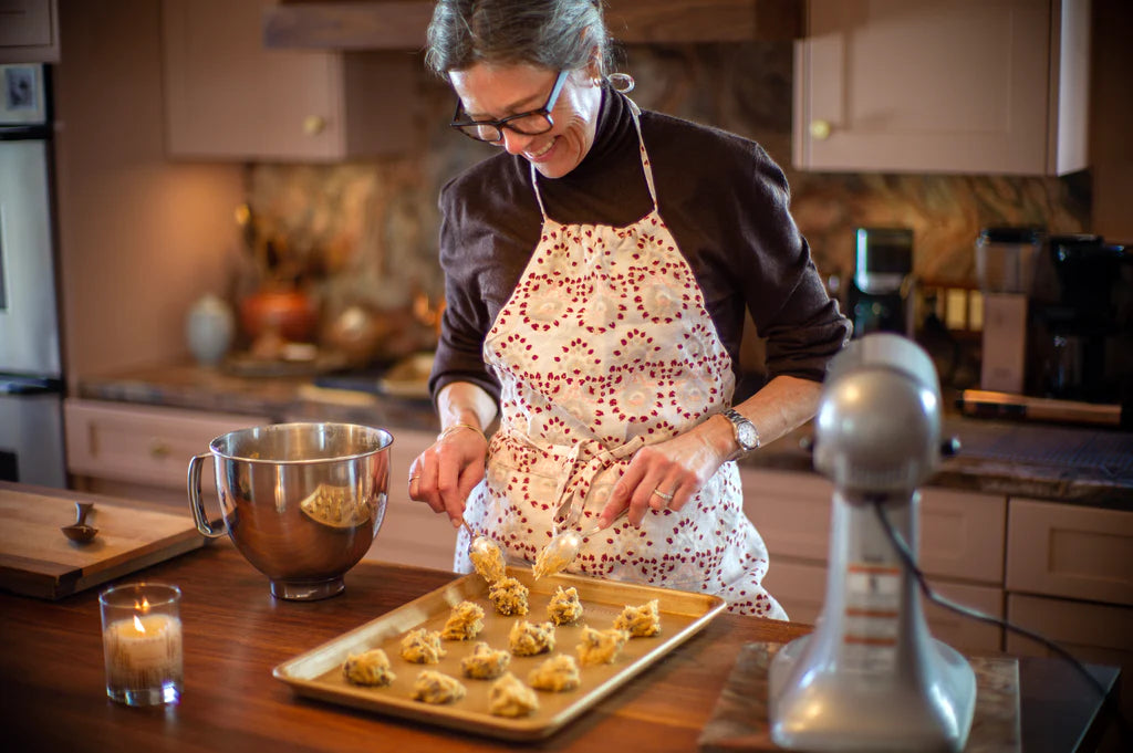 Woman placing cookie dough on a sheetpan