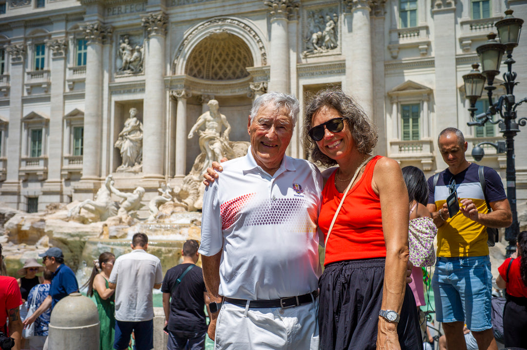 Man and woman standing in front of the Trevi Fountain