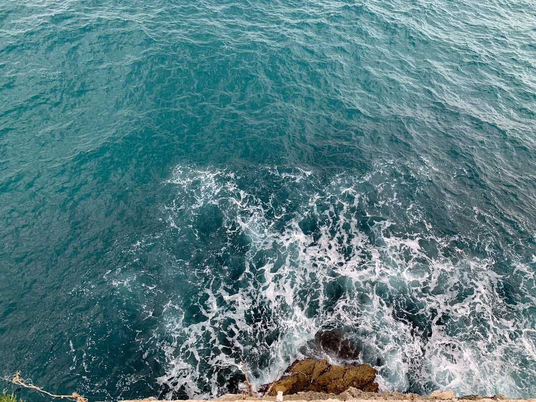 Ocean waves crashing on to rocky shore