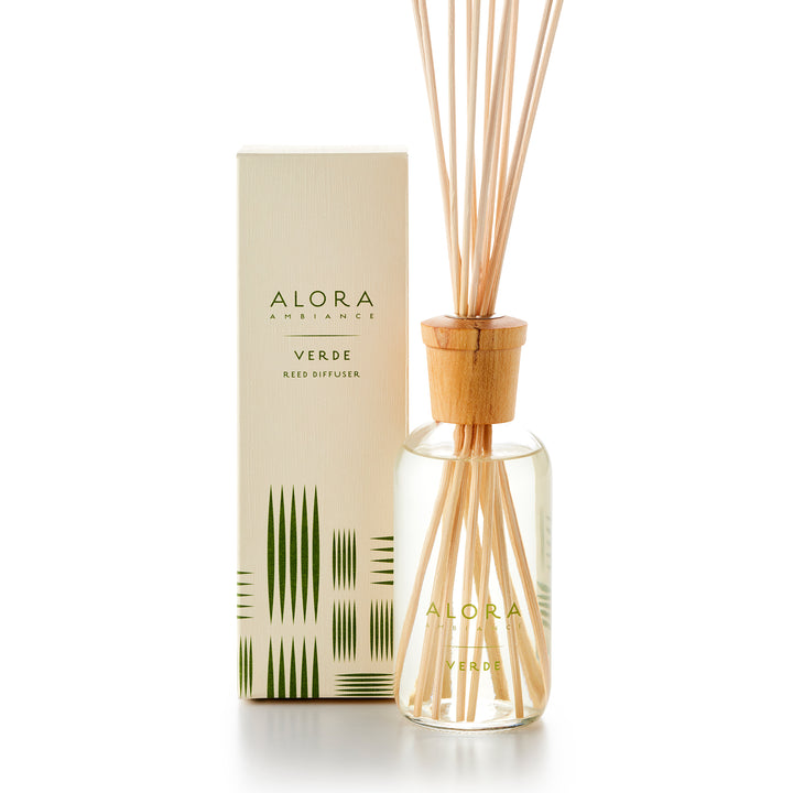 Alora Ambiance 8oz Verde reed diffuser with glass bottle and wooden cap next to tan box with a green striped pattern on it.