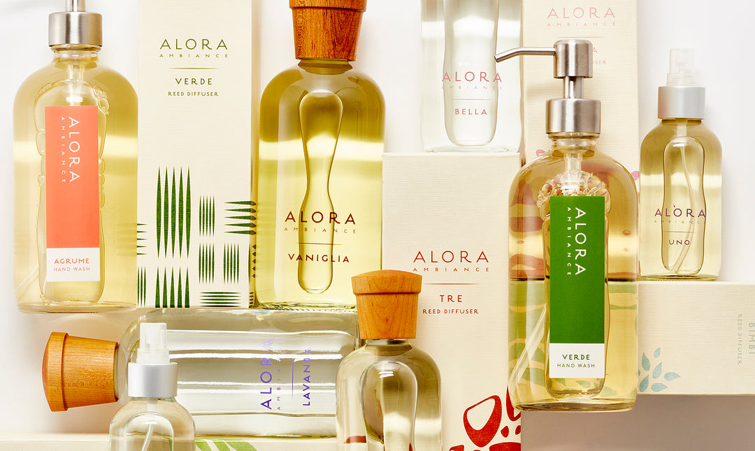 Alora Ambiance boxes, diffuser bottles, room spray bottles and hand wash bottles laying down in a grid-like pattern