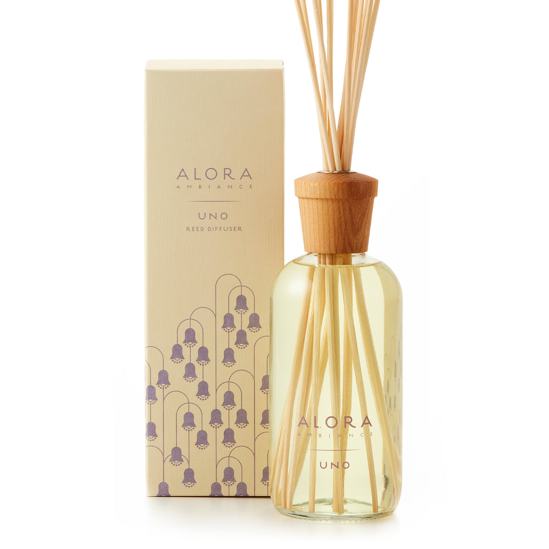 Uno reed diffuser bottle by Alora Ambiance box with purple lily of the valley flowers designed on it