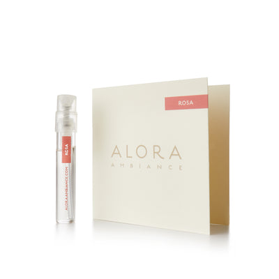 Small clear plastic vial that says “Alora Ambiance” and “Rosa” next to a tan card that also says “Alora Ambiance" and “Rosa”