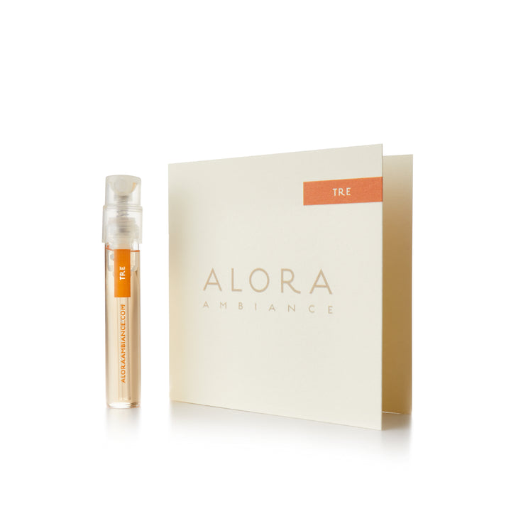 Small clear plastic vial that says “Alora Ambiance” and “Tre” next to a tan card that also says “Alora Ambiance" and “Tre”