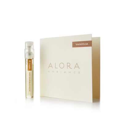 Small clear plastic vial that says “Alora Ambiance” and “Vaniglia” next to a tan card that also says “Alora Ambiance" and “Vaniglia”